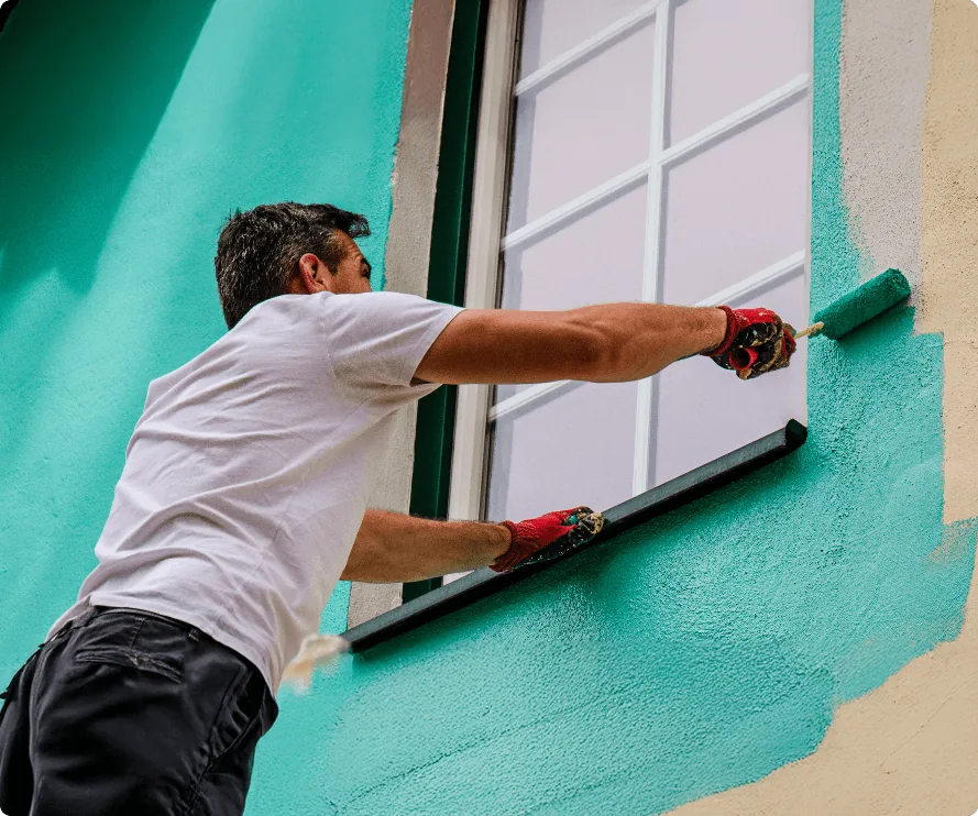 Professional painter and decorator at work on an exterior window in Bournemouth