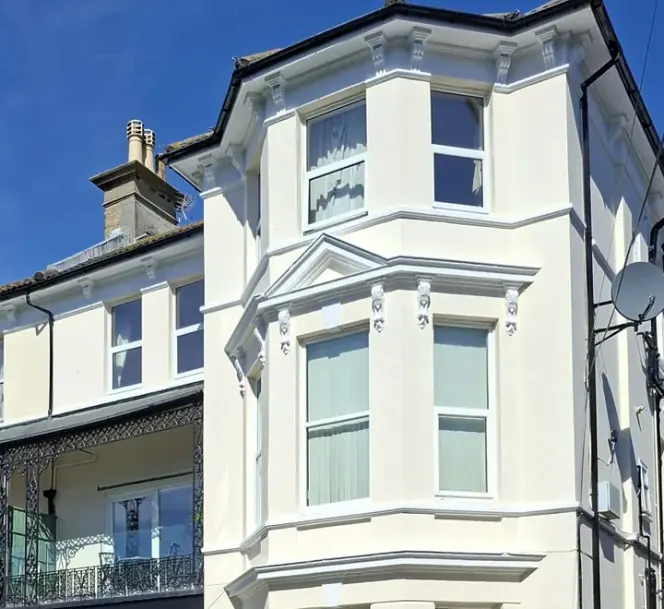 Repainted rendering and bay windows on a block of flats in Boscombe